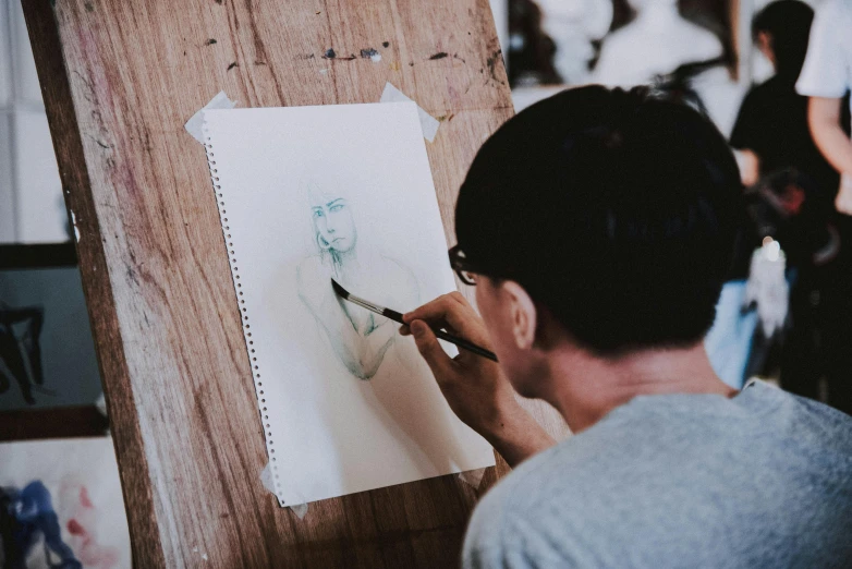a man is using scissors to draw on paper
