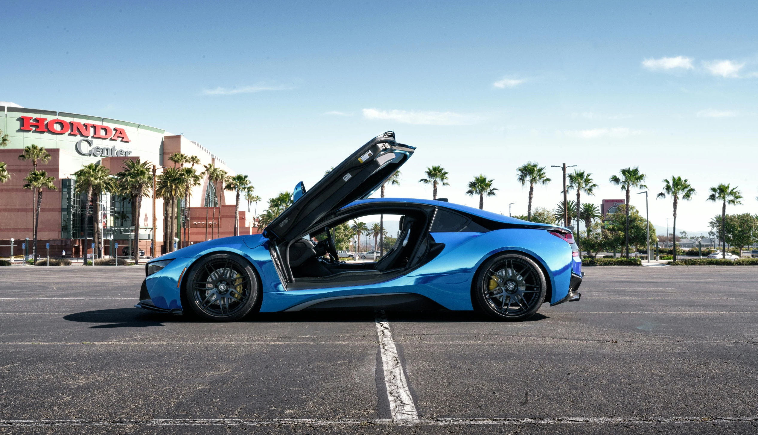 a blue sports car with its door open