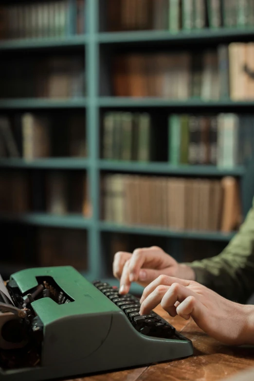 a person typing on an old fashioned typewriter