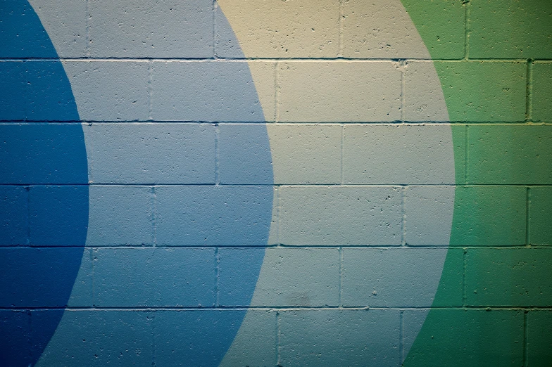 some very pretty blue and green stripes on the side of a building