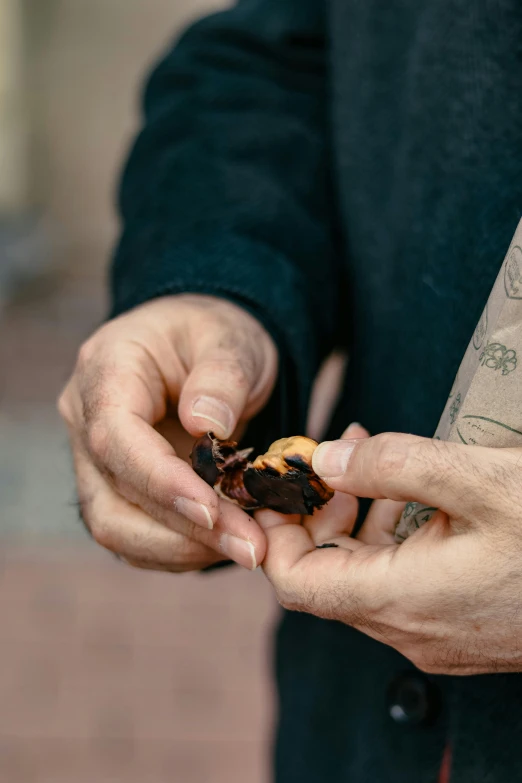 a person with his hands in the dirt holding soing