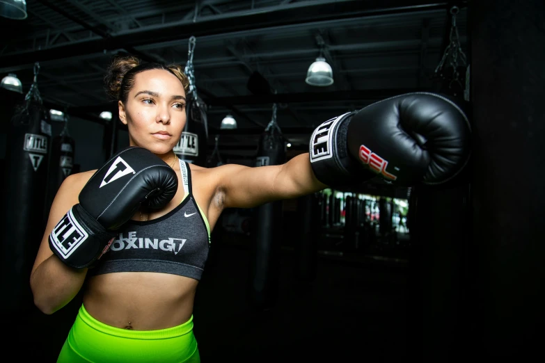 a woman boxer posing with her gloves off