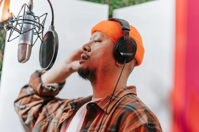 the man is listening to a record on his headphones