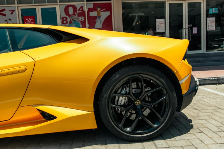 the front end of an electric car parked outside a store