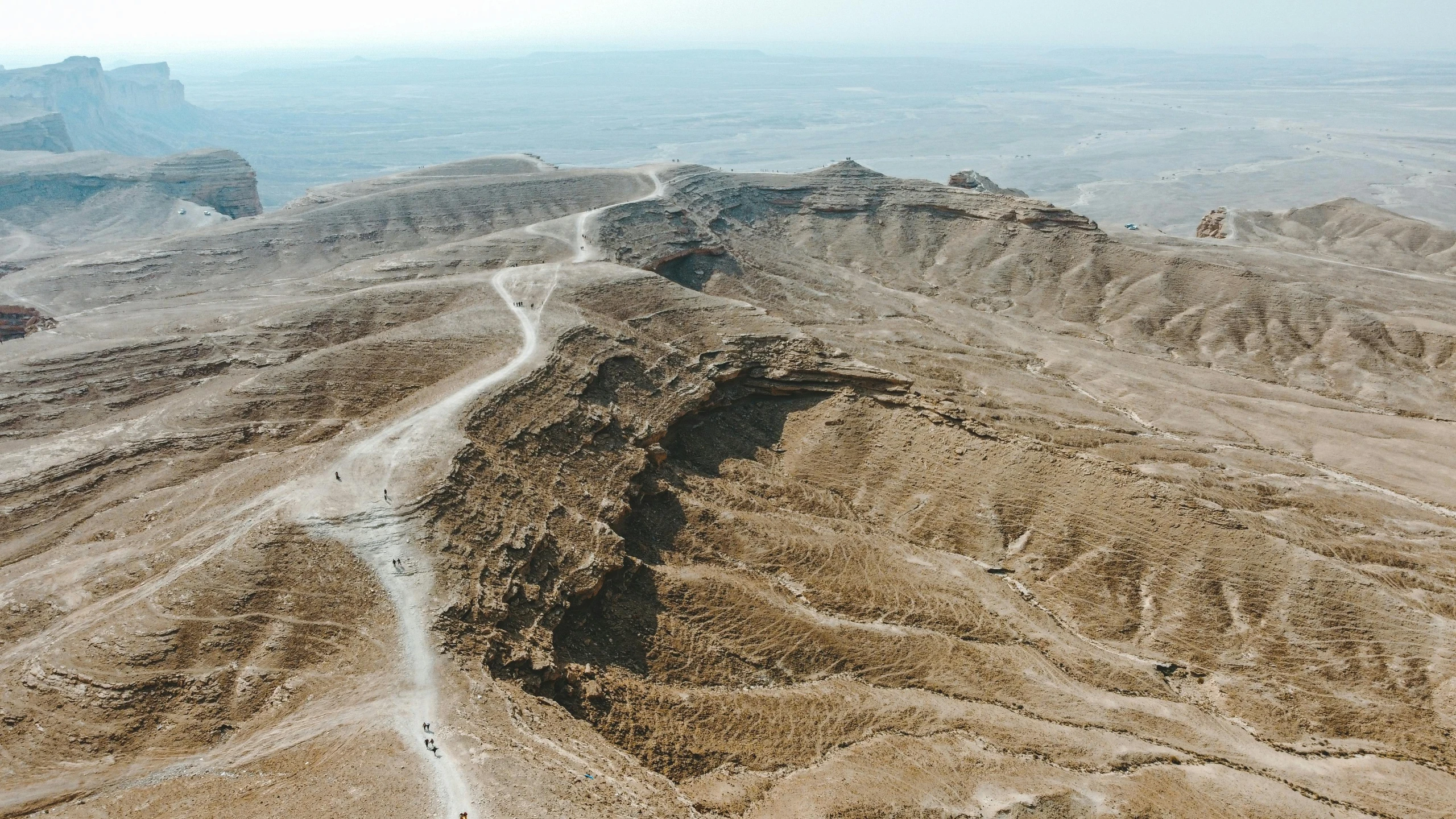 a winding road with multiple mountains in the background