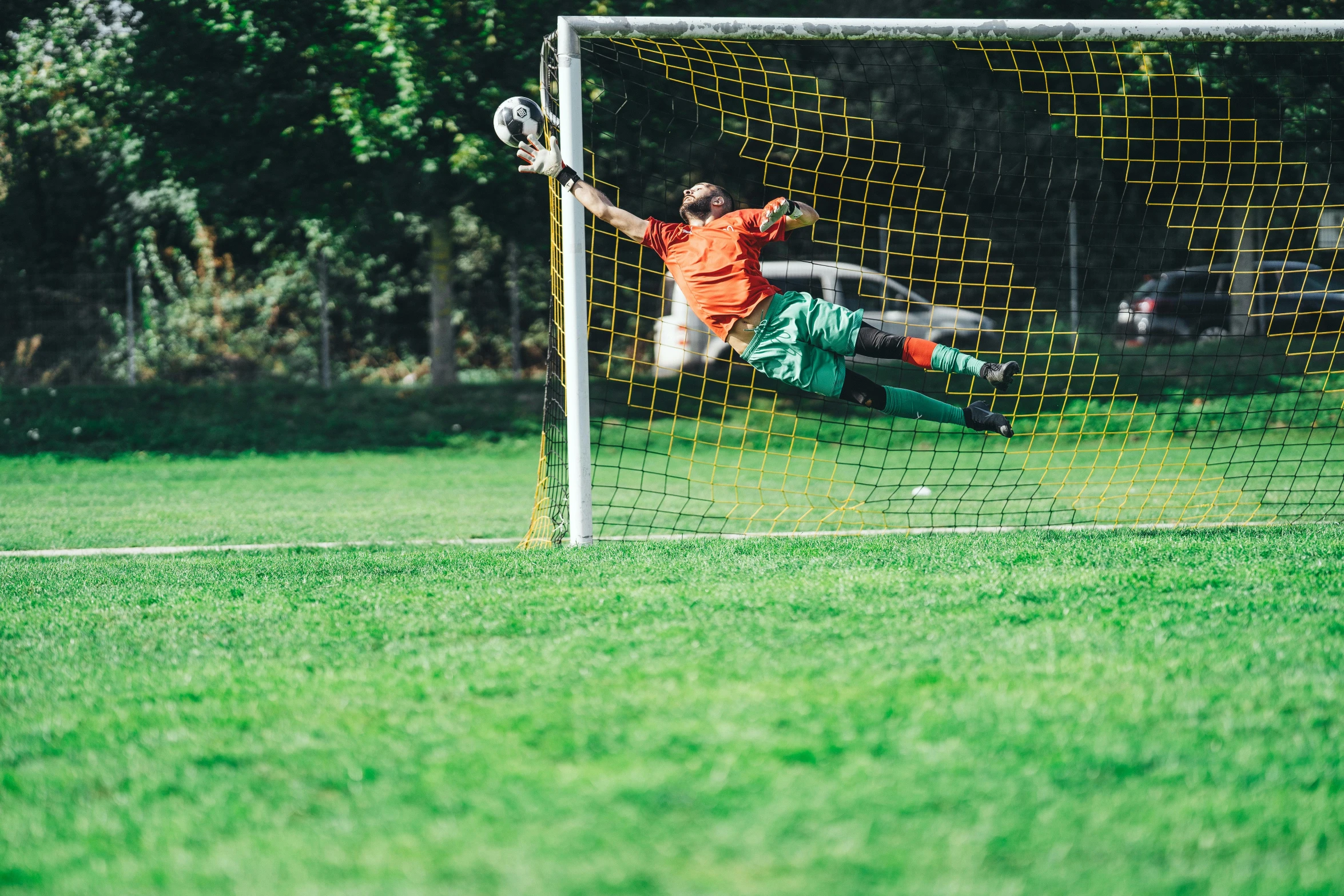 a soccer player who is diving for the ball