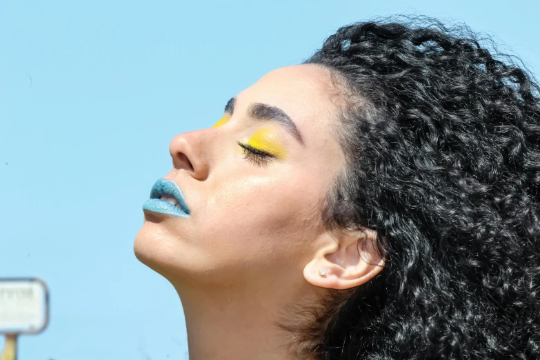 a close up of a woman with colorful makeup