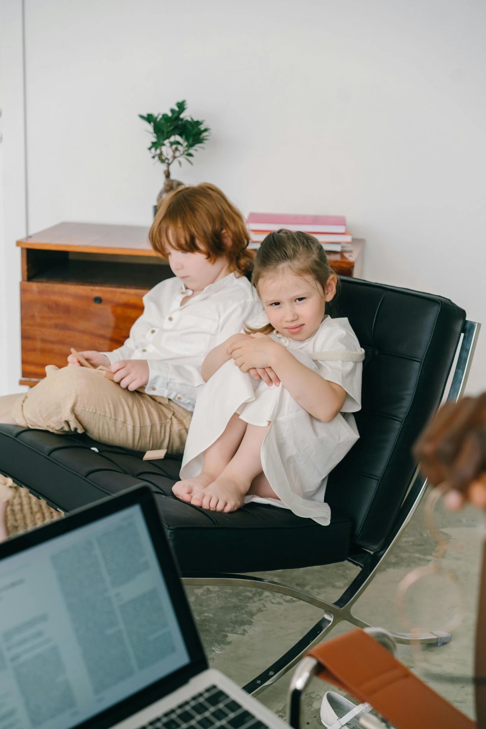 two little girls sitting down next to each other