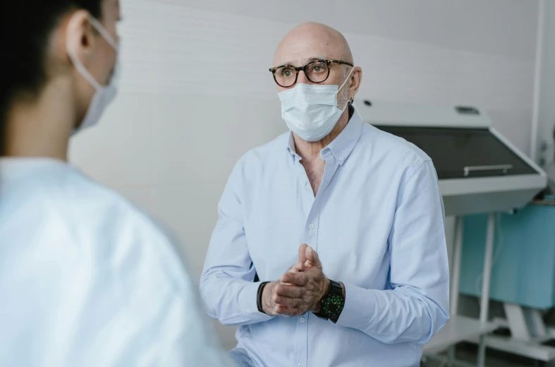 a man in a blue shirt with white face mask