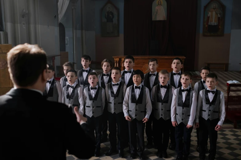 a man giving a choir presentation in front of a large crowd