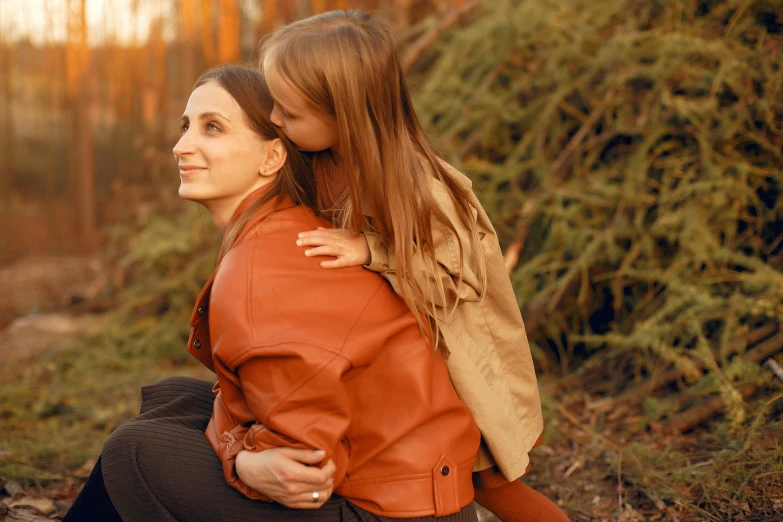 the woman and girl are sitting together