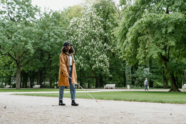 a person standing in the dirt holding a pole