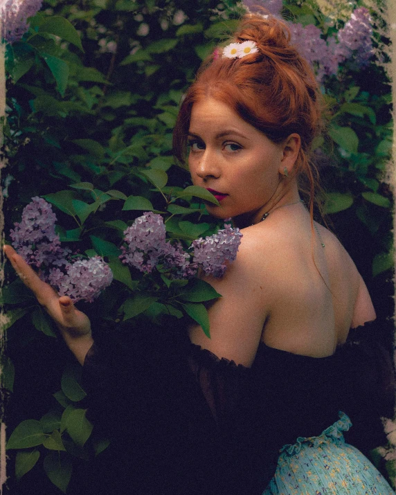 an old fashioned po of a beautiful woman holding some flowers