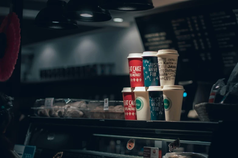 some coffee cups are on top of a counter