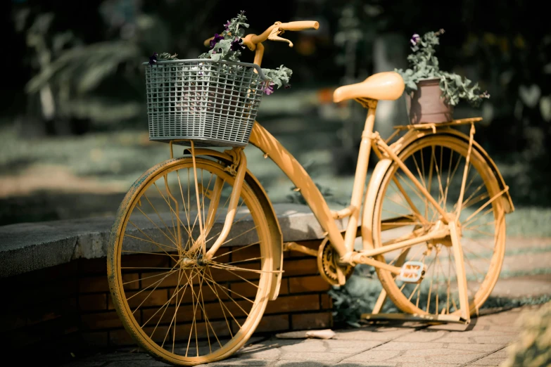 a yellow bicycle is shown parked along the curb