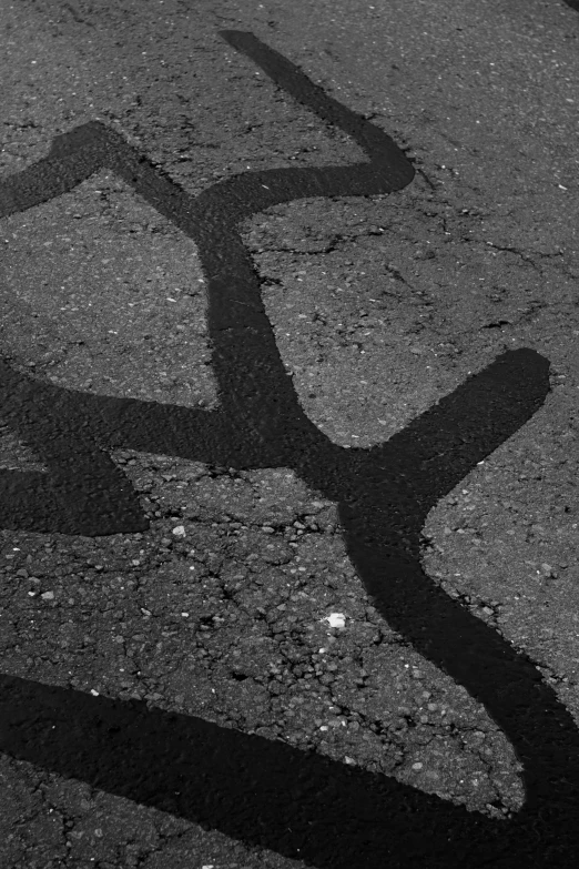 the shadow of a street sign is on the ground