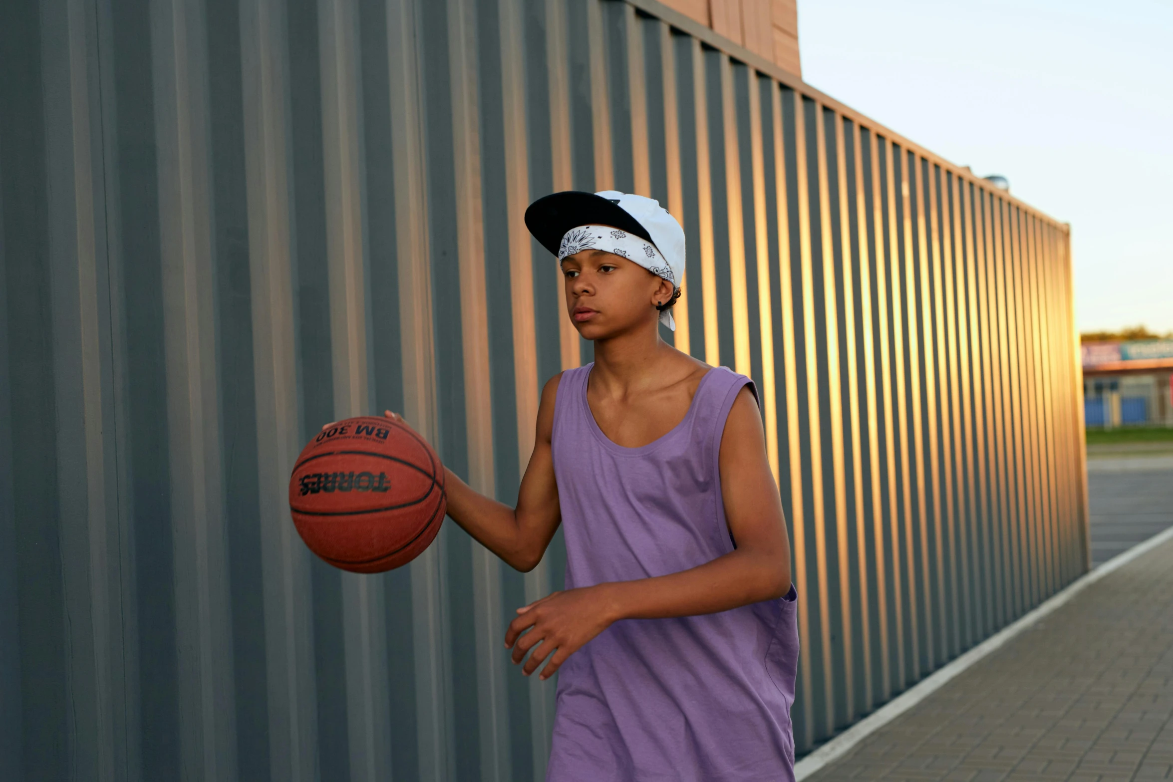 a girl holding a basketball and a towel on her head