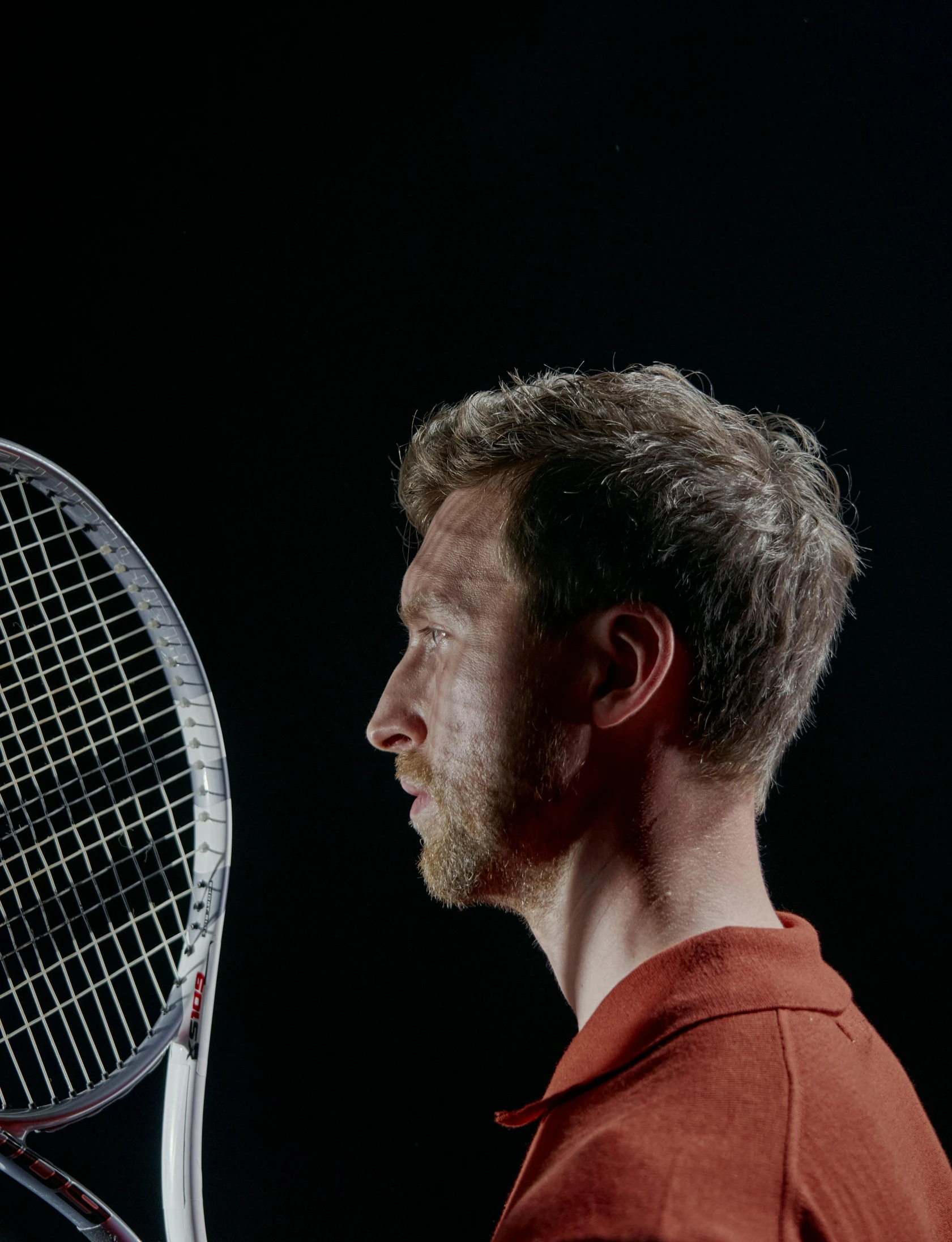 a man holding a tennis racket in his hand