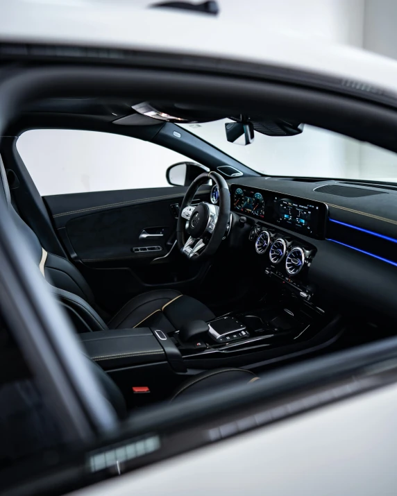 the interior of a silver sports car with blue trim