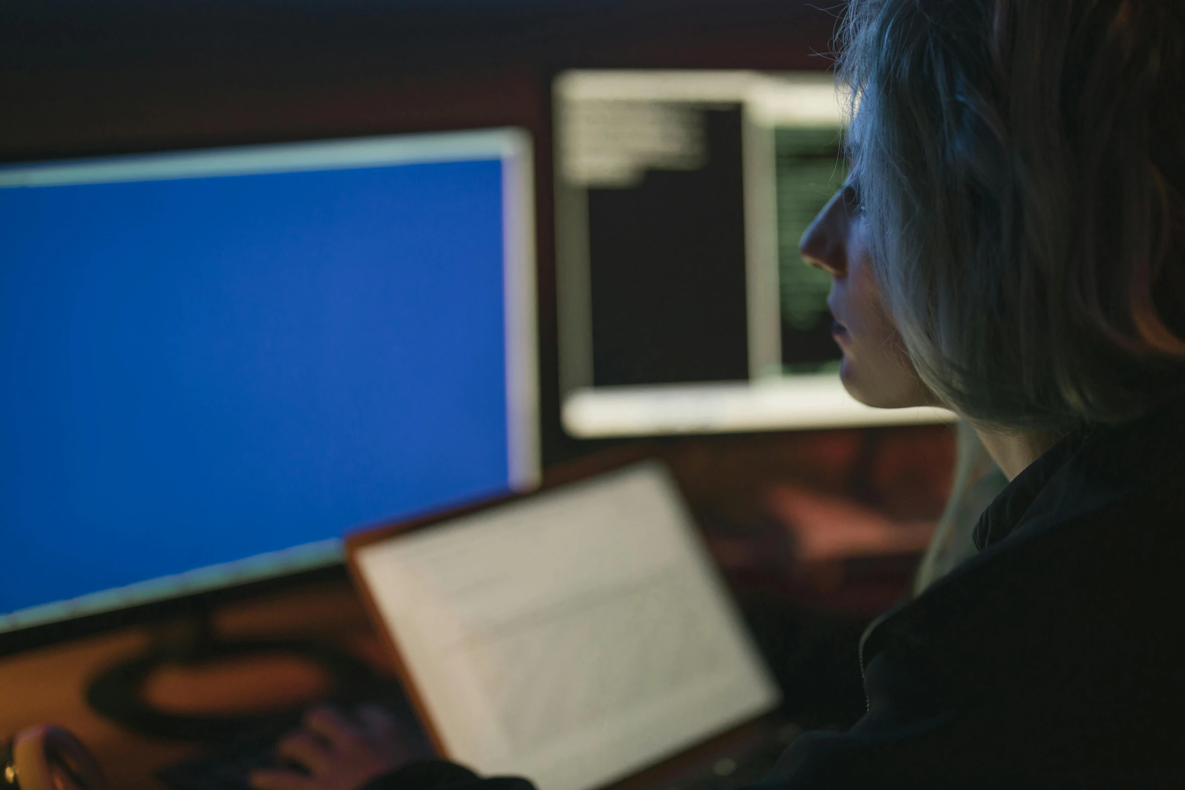 a woman is working at a computer on a desk