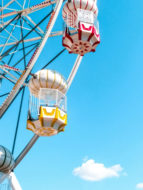 a ferris wheel is spinning against a blue sky