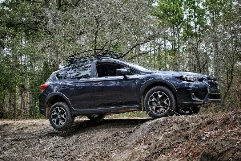 an suv on dirt hill in a forest