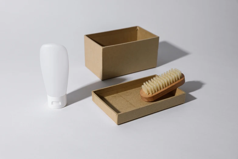 a white brush sitting on top of a brown box