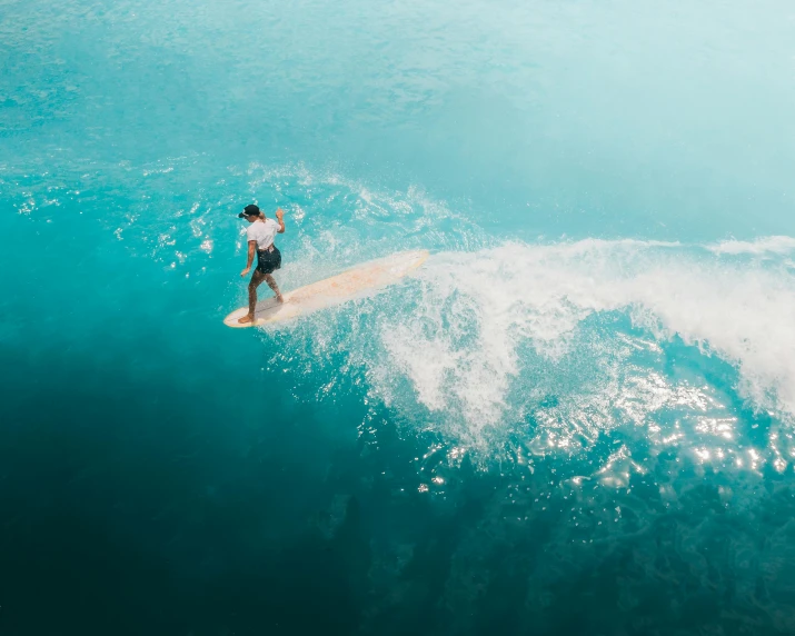 a man surfing on an ocean wave during the day