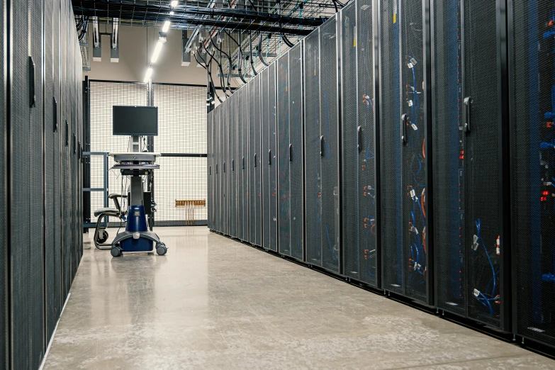 a room with rows of servers and wires