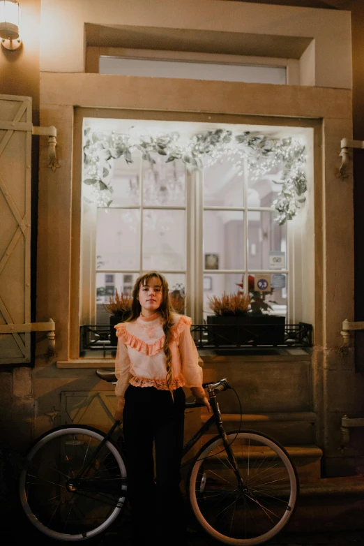 woman holding bike in front of window in daytime