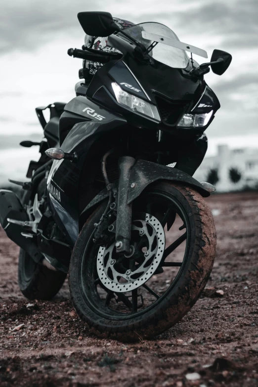 there is a motorcycle sitting on a dirt ground