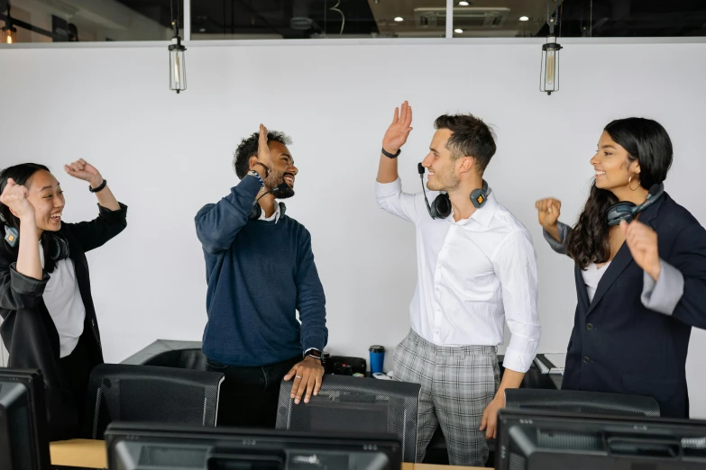 a group of business people greeting one another with a high five