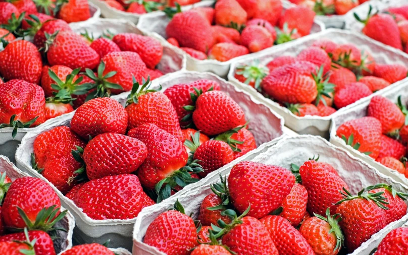 the baskets have strawberries inside of them