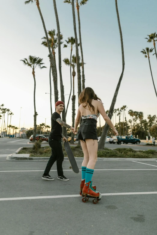 a women who is on a skateboard walking down the street