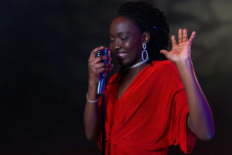 a woman in a red dress and earrings talks on her cell phone