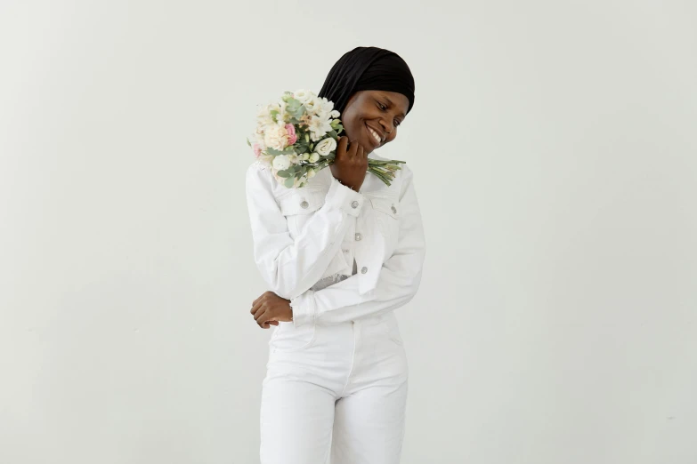 a black woman in white suit and flowers