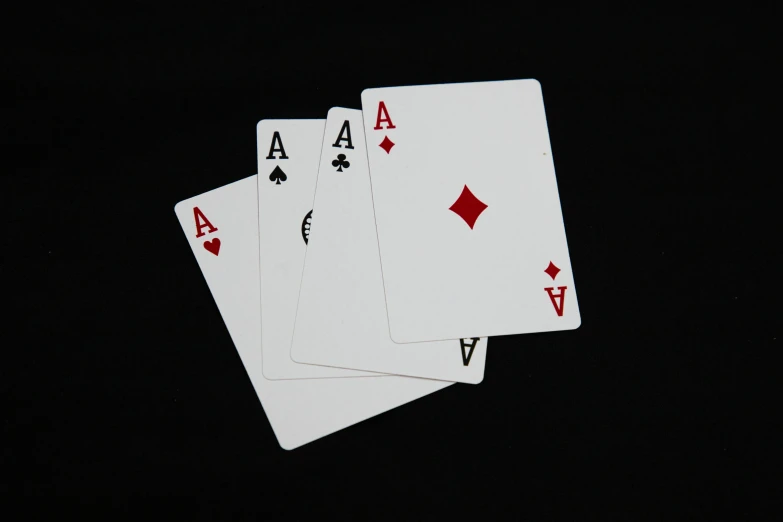 five card set laying on a table in the dark
