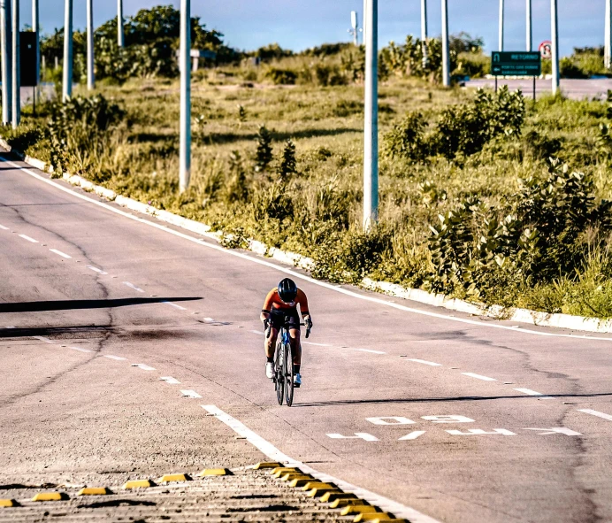 a person riding a bicycle down a road