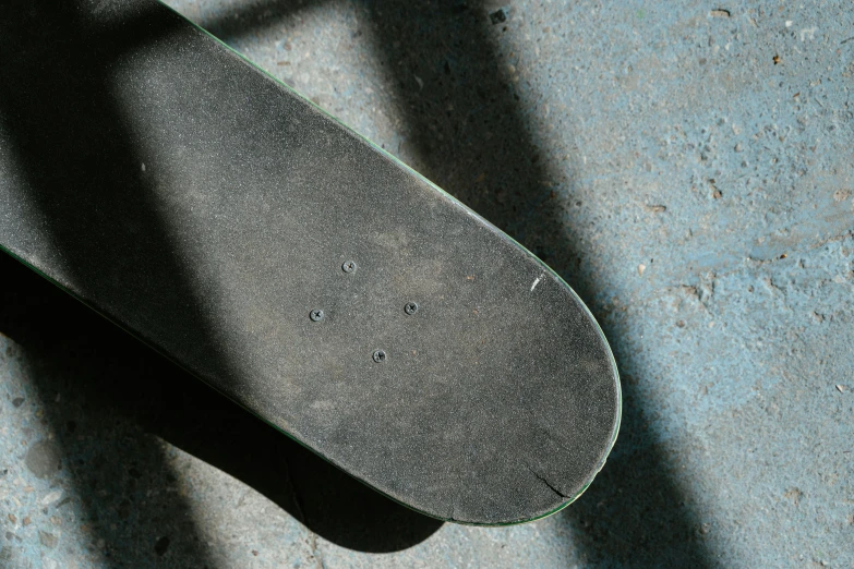 a skateboard laying on its side and missing the wheel