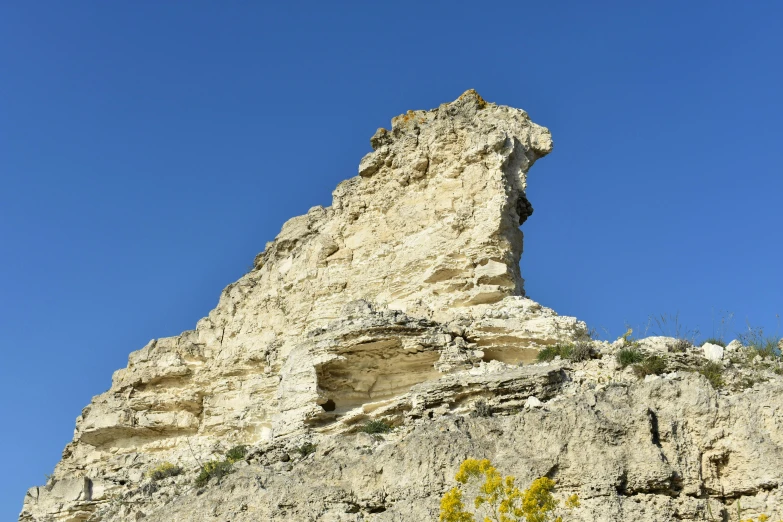 a tall mountain with a clock tower and sky above it