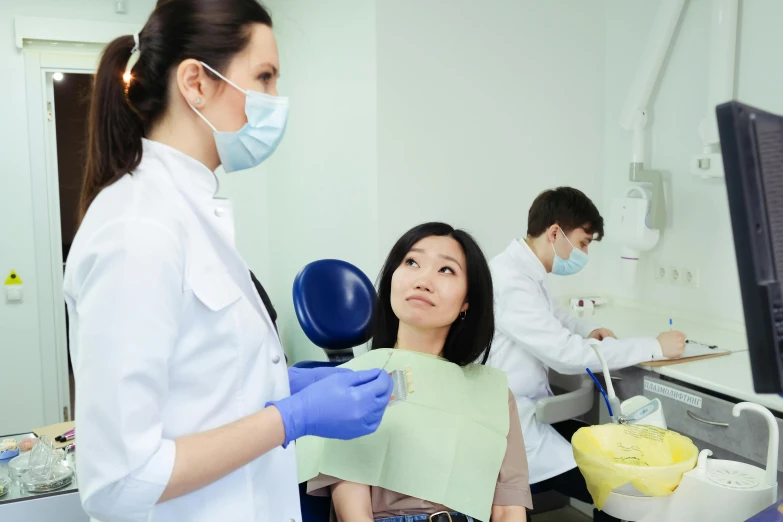 a woman in an operating room undergoing a procedure on her face