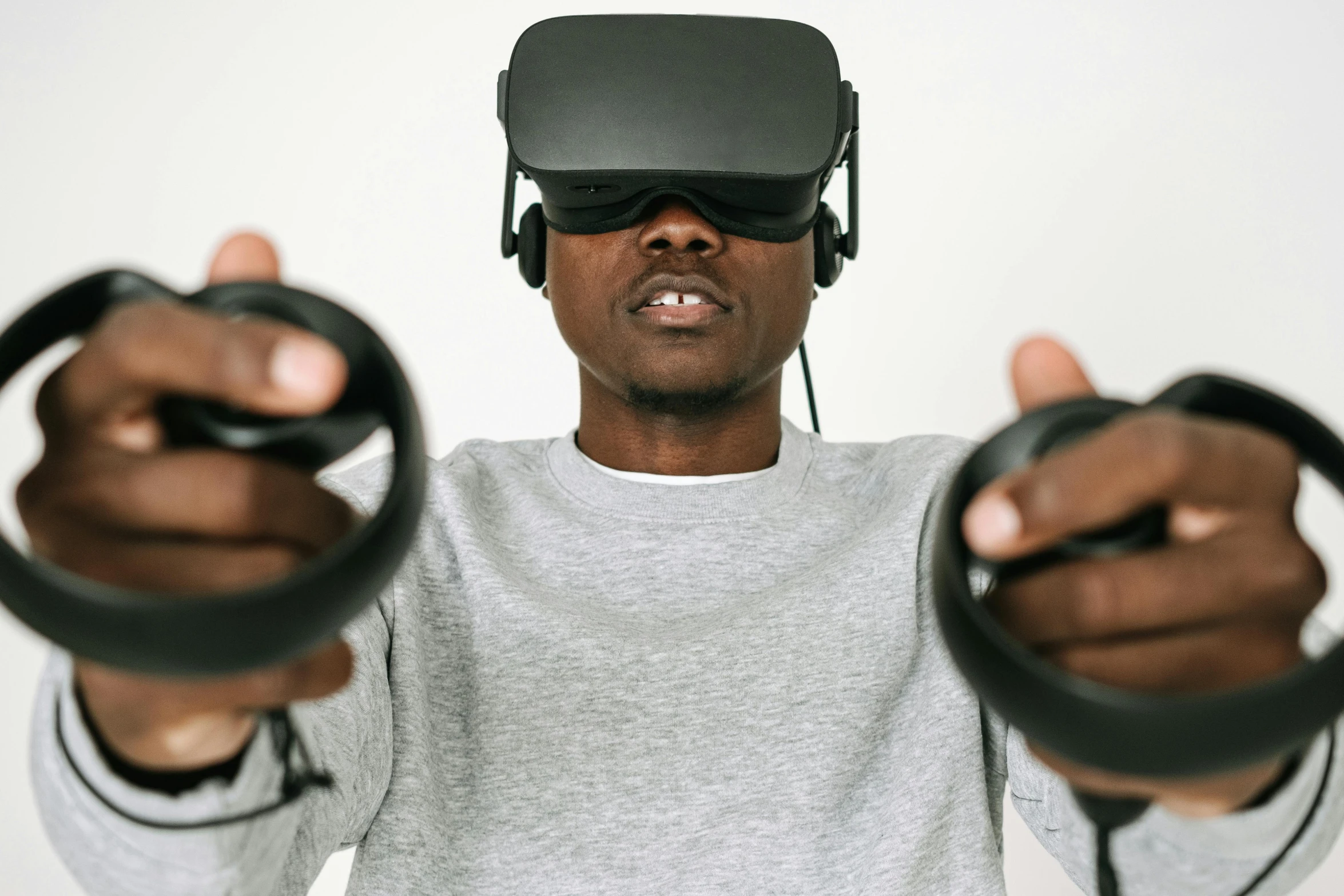 a person wearing some black head phones and a vr headset