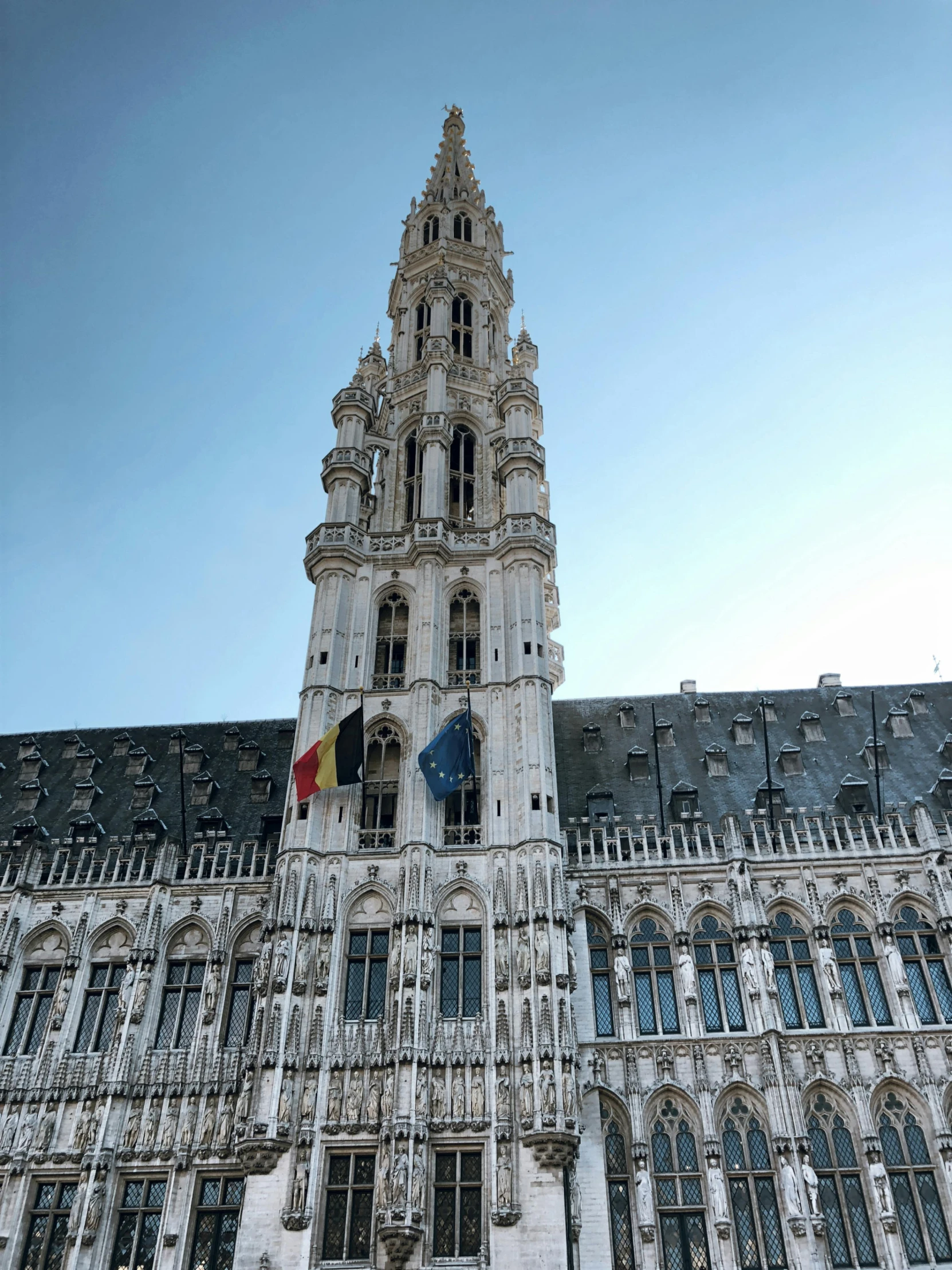 the clock tower on a large building is very tall