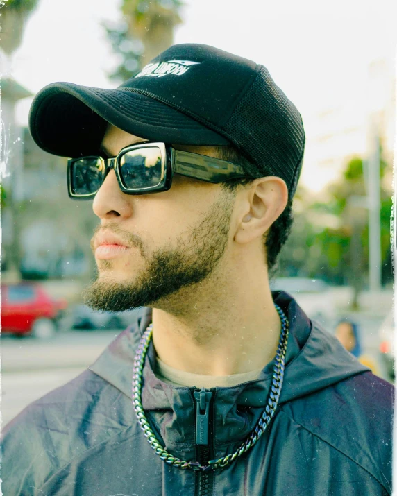 a man with a beard wearing a hat and sunglasses