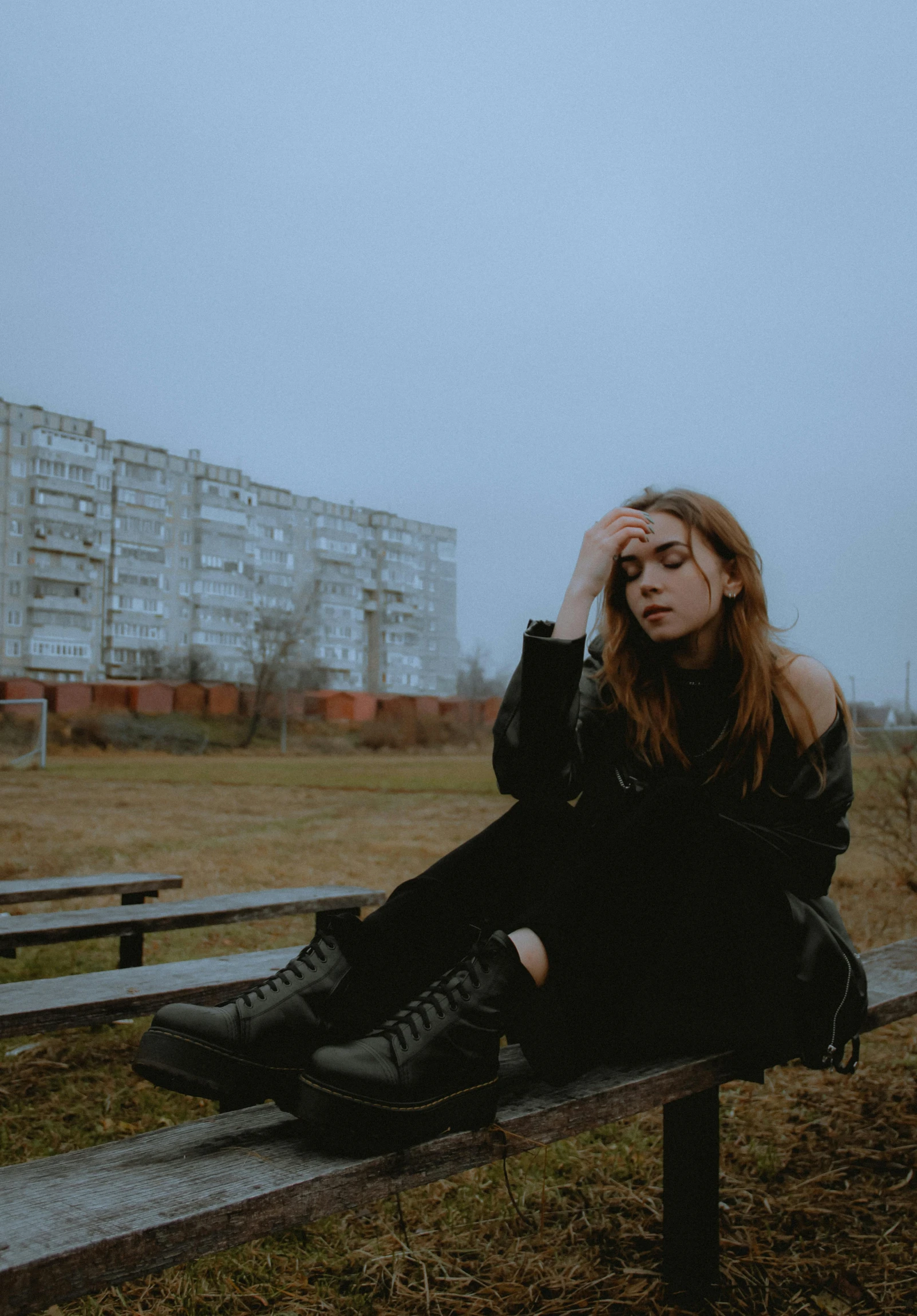 a person sitting on a bench and looking up