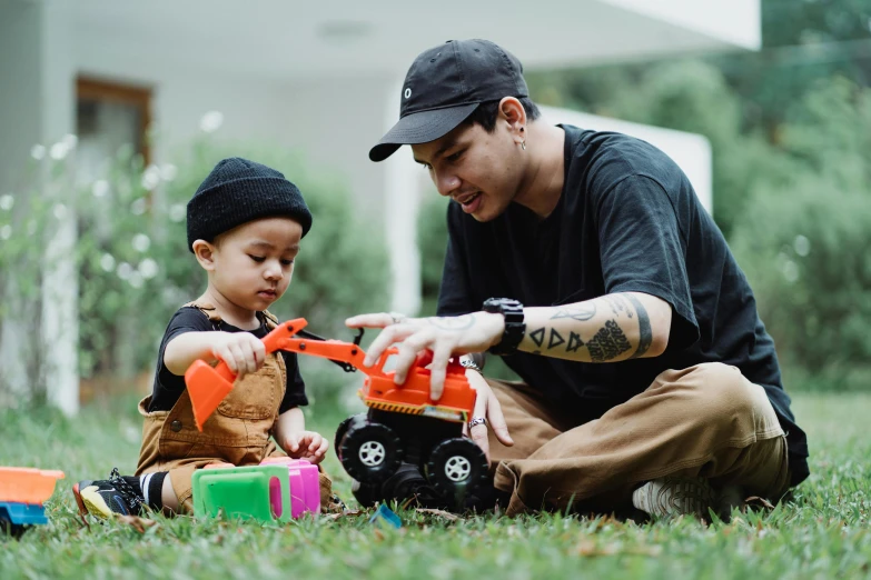 a man and a boy playing with a building set