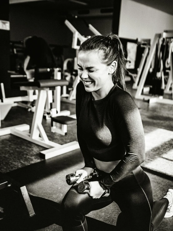 woman doing seated crossfit in a gym