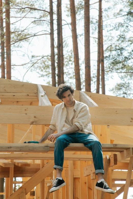 a person is sitting on a beam in a home under construction