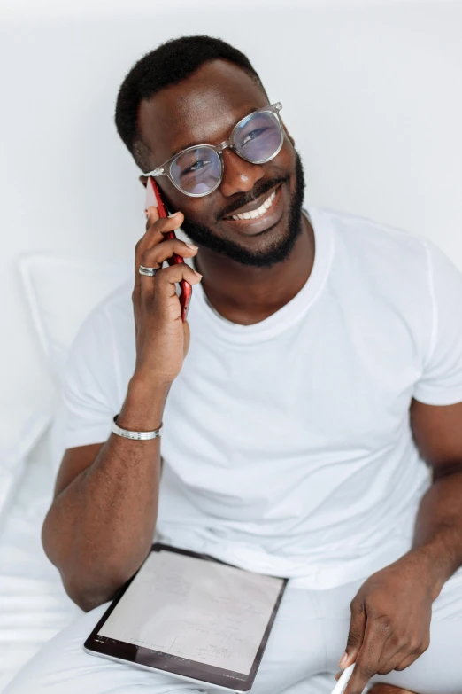 a person talking on the phone next to a piece of paper