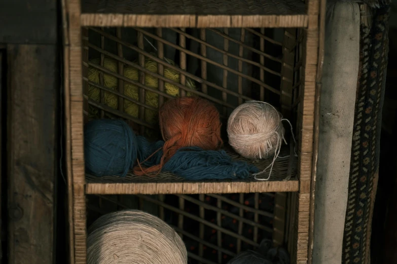 a shelf filled with assorted yarn and yarn balles